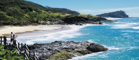 a person standing on a rocky beach