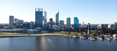 a bridge over a body of water with a city in the background